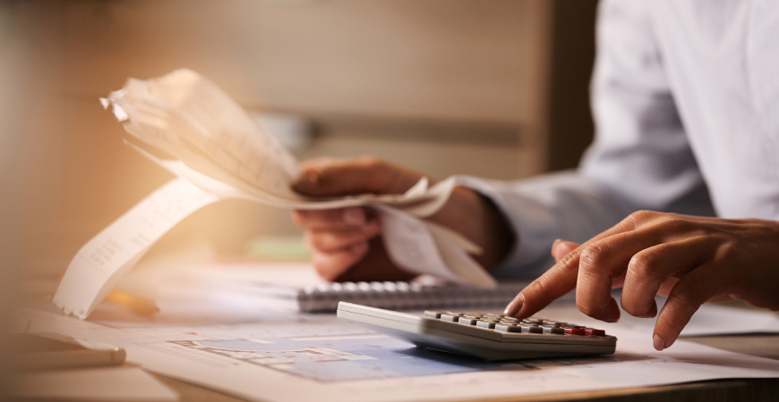 Profissional analisando documentos financeiros sobre Distinção entre Custos e despesas e classificação contábil