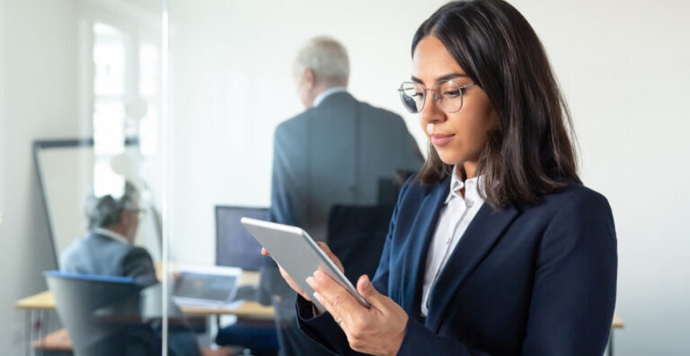 Profissional em ambiente corporativo consultando tablet sobre CBenef e Seus Impactos no cumprimento das obrigações acessórias